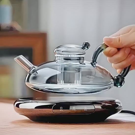 Video showcasing the Glass Flower Tea Teapot Set, featuring heat-resistant glass, British-style design, blooming tea brewing, and a luxury tea experience.